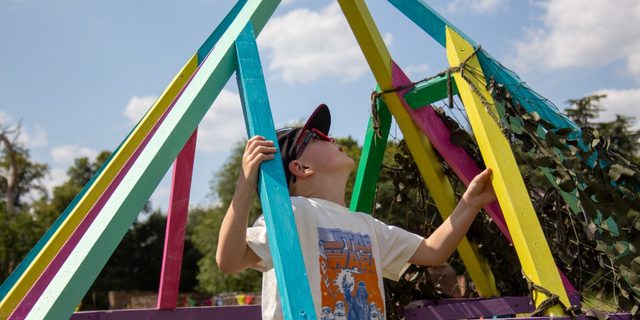 Child exploring a giant obstacle course in The Garden of Imagination at Calke Abbey