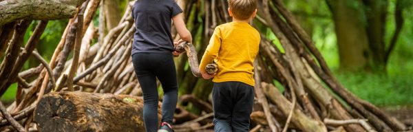Children building a den in the woodland