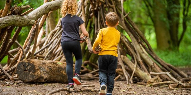 Children building a den in the woodland